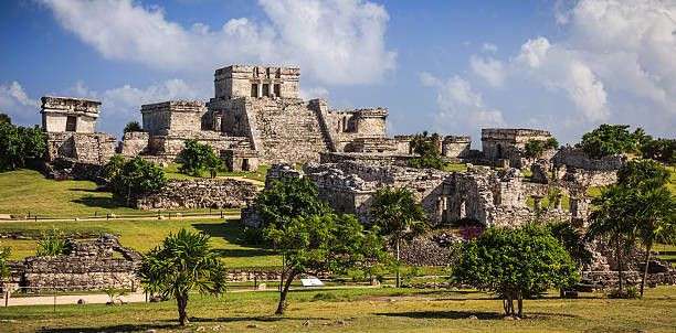 Ruins of Tulum, a pre-Columbian Mayan walled city, perched on a cliff overlooking the Caribbean Sea in Mexico